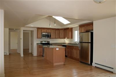 126 Long Road Harwich, MA 02645 - Photo 2 of 8 a kitchen with stainless steel appliances granite countertop a refrigerator and a stove top oven