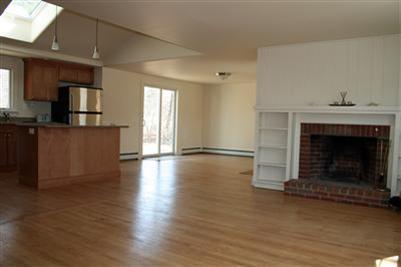 126 Long Road Harwich, MA 02645 - Photo 4 of 8 a living room with hard wood floors and a fireplace