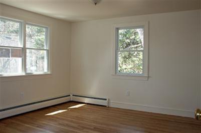 126 Long Road Harwich, MA 02645 - Photo 5 of 8 a view of an empty room with wooden floor and a window