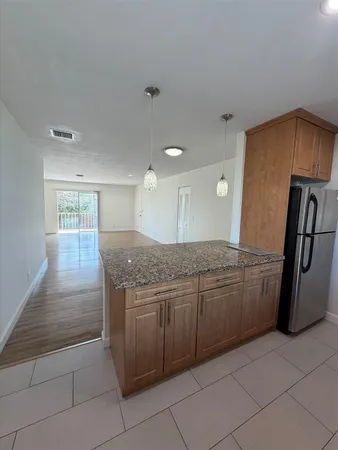 a bathroom with a granite countertop sink a toilet and a mirror