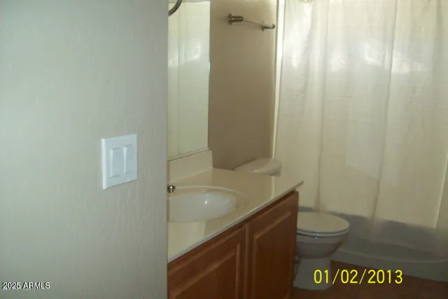 a bathroom with a shower and a sink