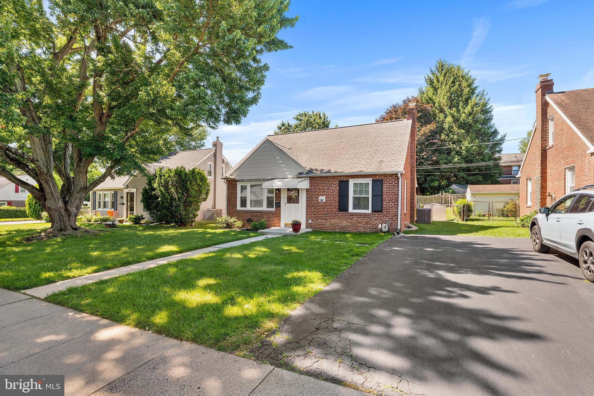 504 Lawrence Road Havertown, PA 19083 - Photo 2 of 20 a view of a white house next to a yard with big trees