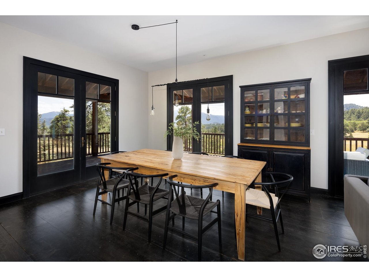 8558 Flagstaff Road Boulder, CO 80302 - Photo 23 of 50 a dining room with a wooden table and chairs
