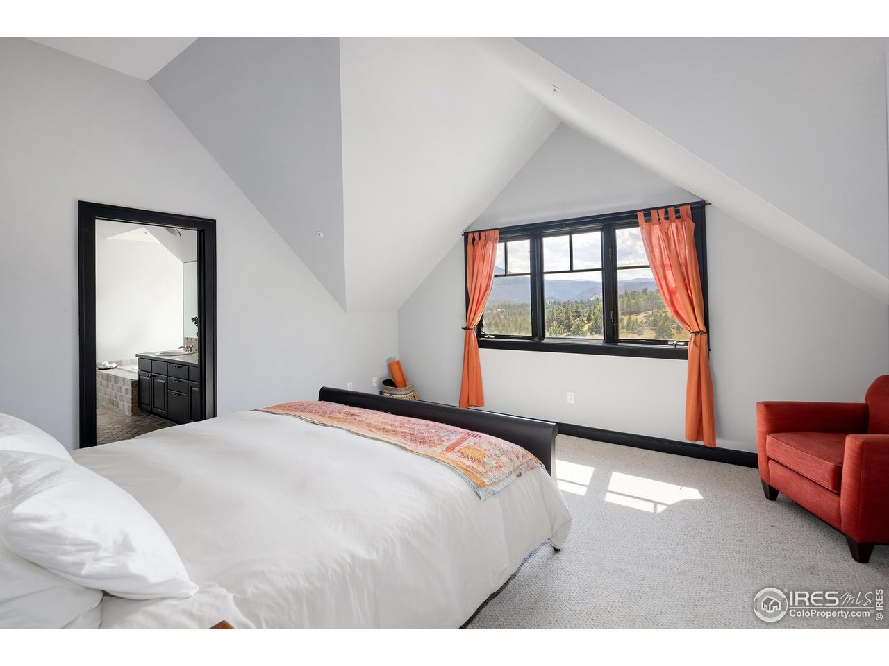 8558 Flagstaff Road Boulder, CO 80302 - Photo 32 of 50 a bedroom with a bed and a large window