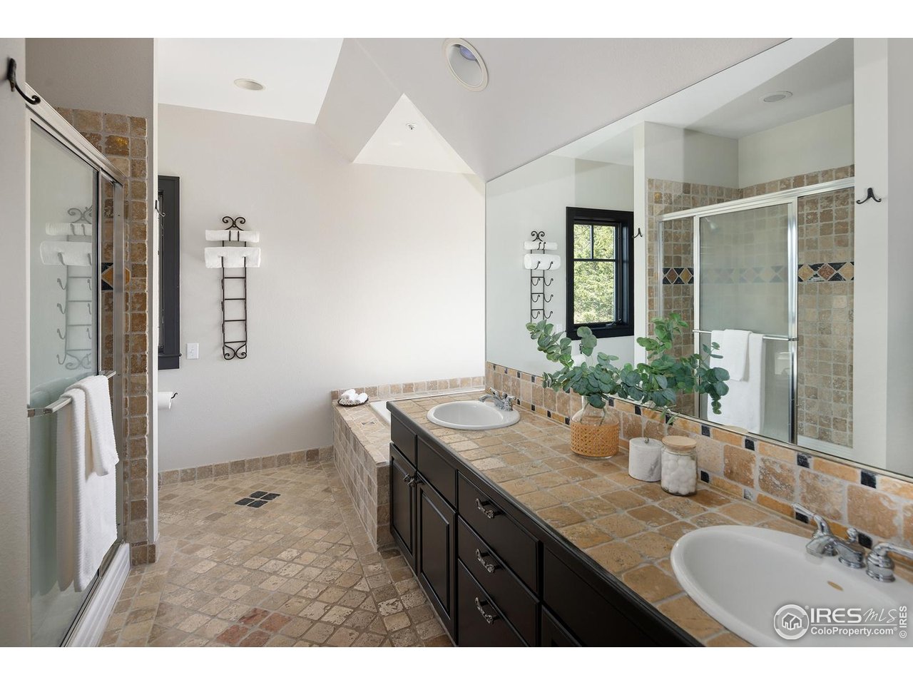 8558 Flagstaff Road Boulder, CO 80302 - Photo 33 of 50 a bathroom with a granite countertop sink and a mirror