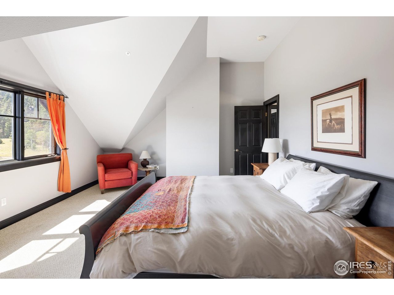 8558 Flagstaff Road Boulder, CO 80302 - Photo 10 of 50 a bedroom with a bed and wooden floor