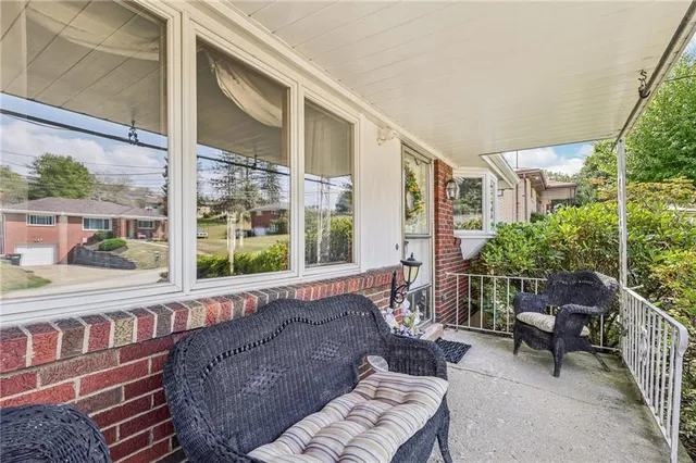 a balcony with furniture and a potted plant