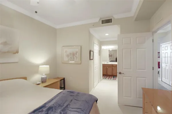 a bedroom with a bed and a lamp