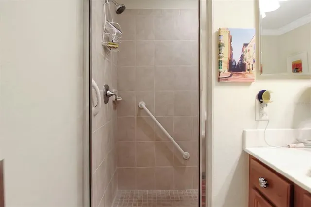 a bathroom with a shower sink and mirror