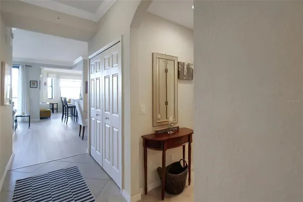 a view of a hallway with wooden floor and windows