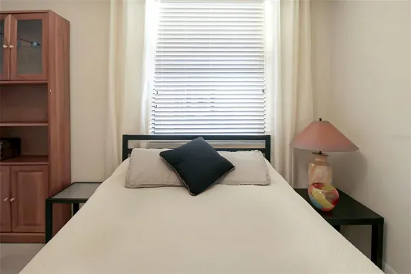 a bedroom with a bed and a window