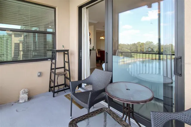 a view of a balcony with wooden floor & fence