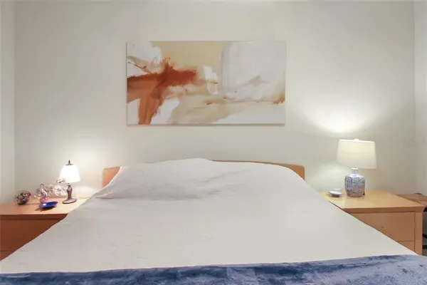 a bedroom with a bed and a night stand