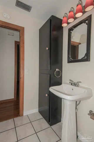 a kitchen with a refrigerator a stove top oven and cabinets
