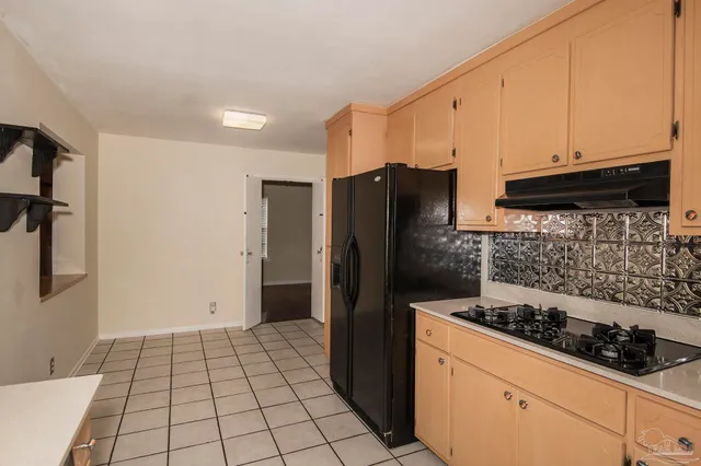 a bathroom with a stove and cabinets