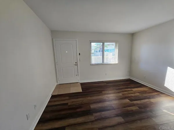 wooden floor in an empty room with a window