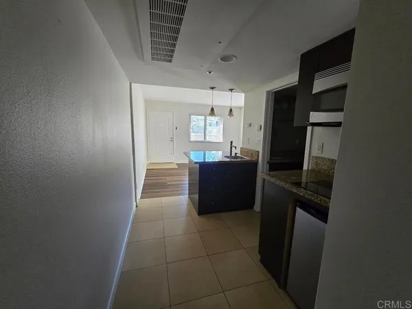 a kitchen with granite countertop a refrigerator and a sink
