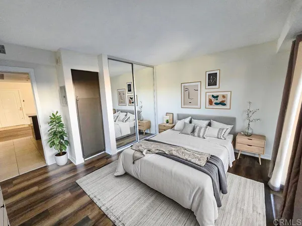 a bedroom with a bed and a large window