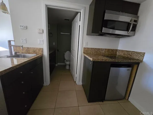 a kitchen with a sink and a microwave