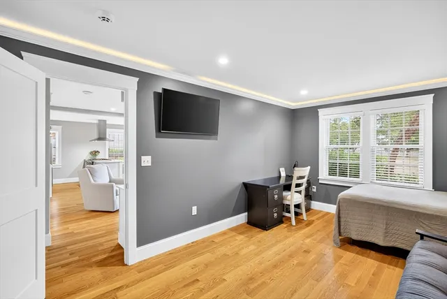 a bedroom with furniture and a flat screen tv