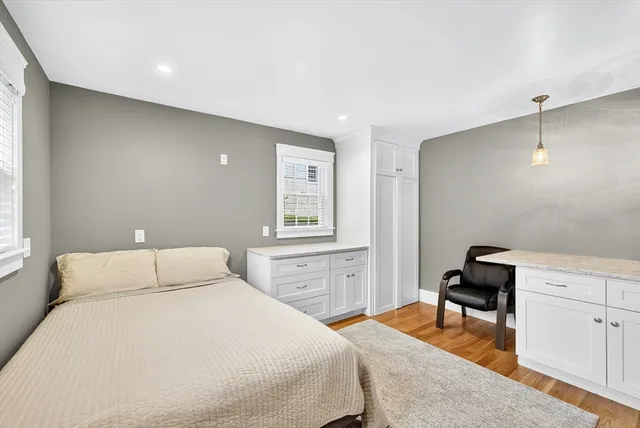 a bedroom with a bed and a dresser in it