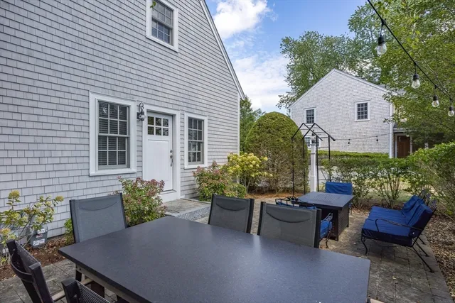 a backyard of a house with outdoor seating