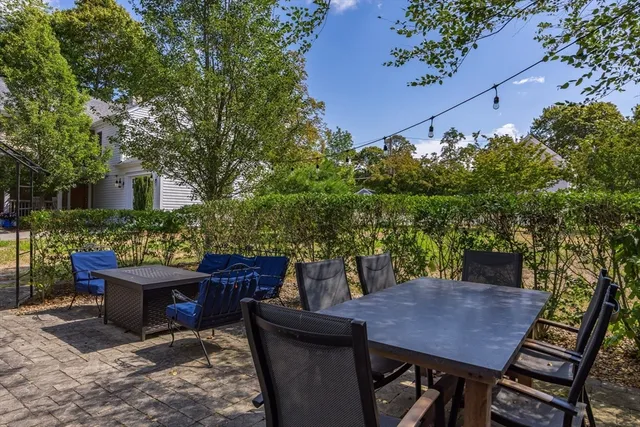 a view of a patio with table and chairs and potted plants