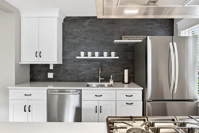 a kitchen with cabinets and stainless steel appliances
