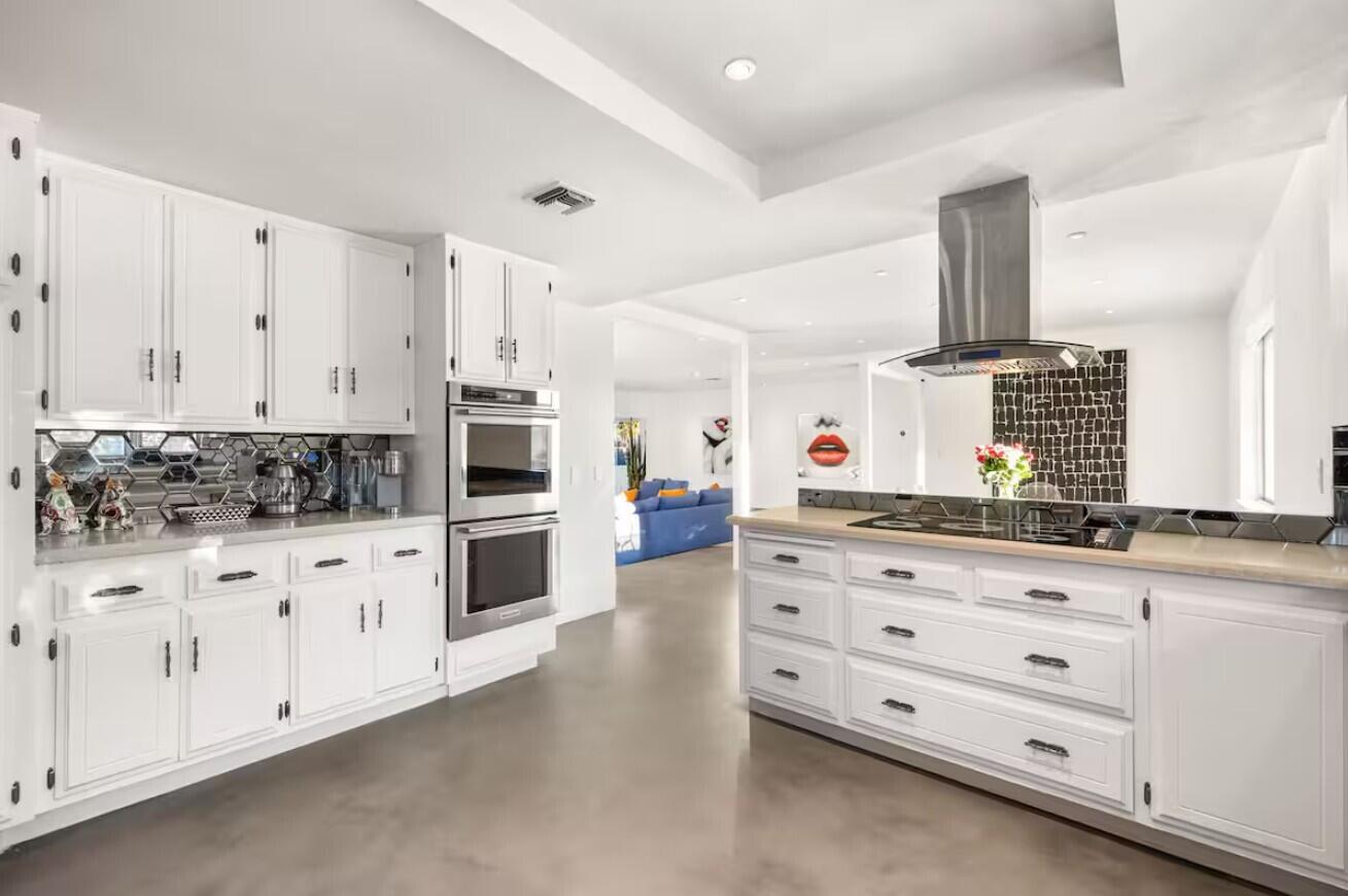 6451 Red Bluff Avenue Yucca Valley, CA 92284 - Photo 17 of 71 a kitchen with granite countertop white cabinets and stainless steel appliances