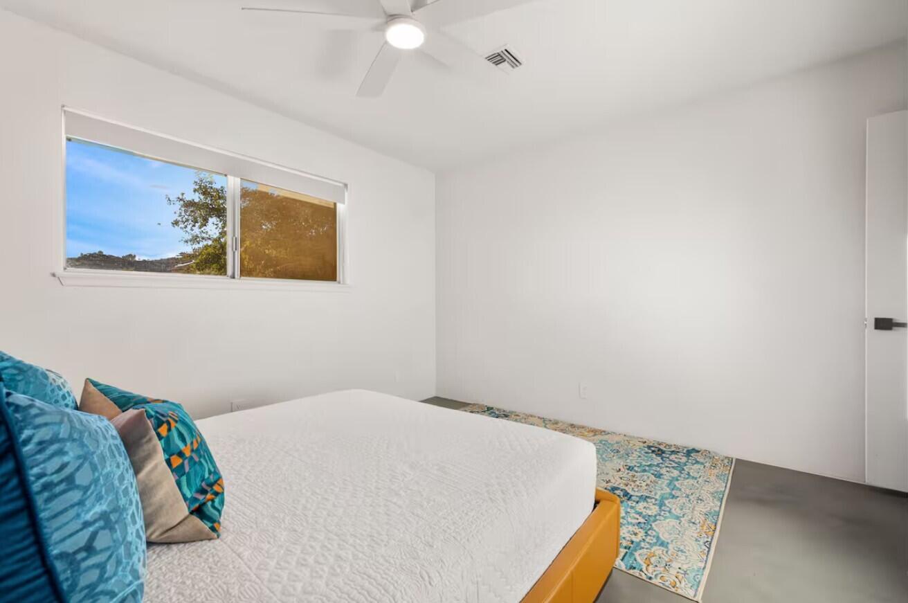 6451 Red Bluff Avenue Yucca Valley, CA 92284 - Photo 41 of 71 a bedroom with a bed and a painting on the wall