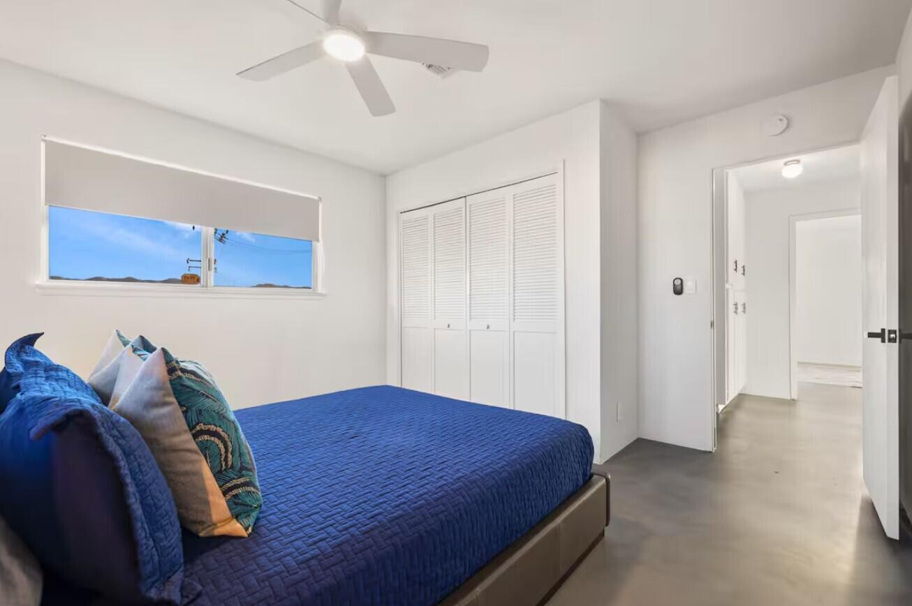 6451 Red Bluff Avenue Yucca Valley, CA 92284 - Photo 44 of 71 a bedroom with a bed and a painting on the wall