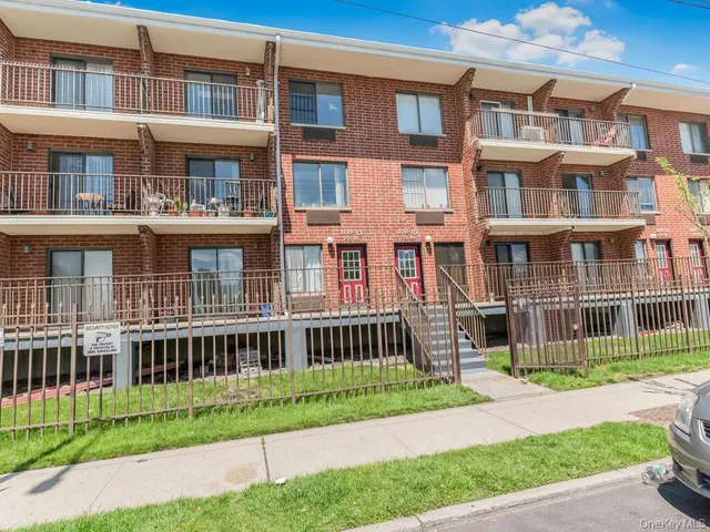 a view of a brick building next to a yard