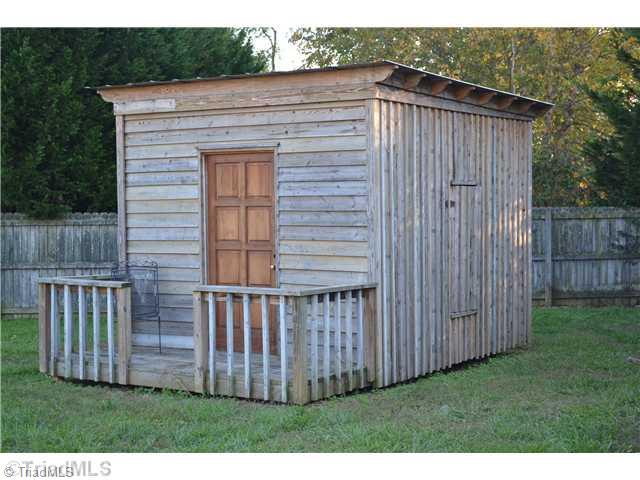 7535 Strawberry Road Summerfield, NC 27358 - Photo 11 of 13 Exterior Back. Storage buildings remain