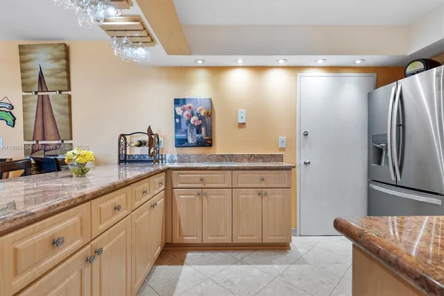 a spacious bathroom with a granite countertop sink and a mirror