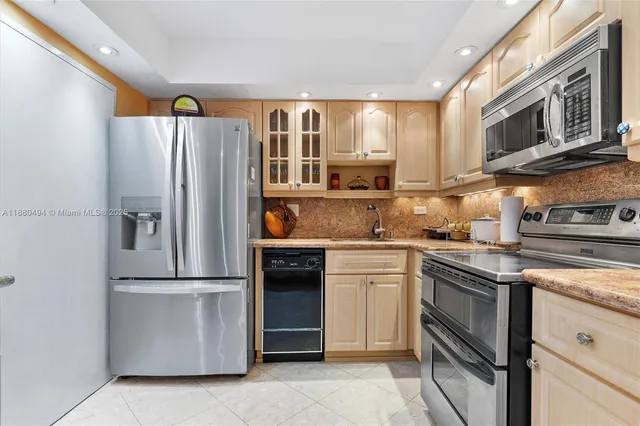 a kitchen with stainless steel appliances granite countertop a refrigerator stove and microwave