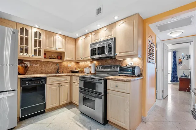 a kitchen with stainless steel appliances granite countertop a stove and a sink