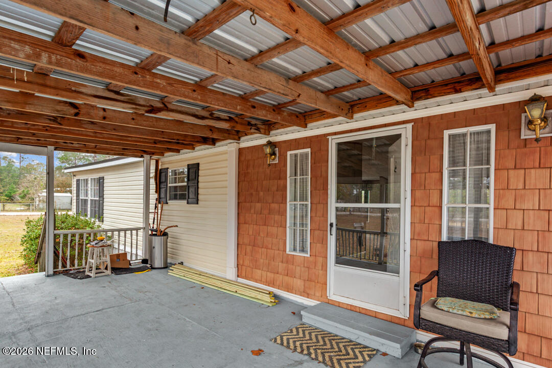 a view of a room with wooden floor and windows