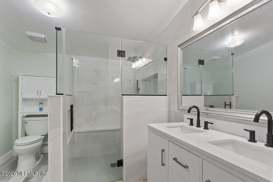 5316 Carter Spencer Road Middleburg, FL 32068 - Photo 11 of 19 a bathroom with a toilet sink double and mirror