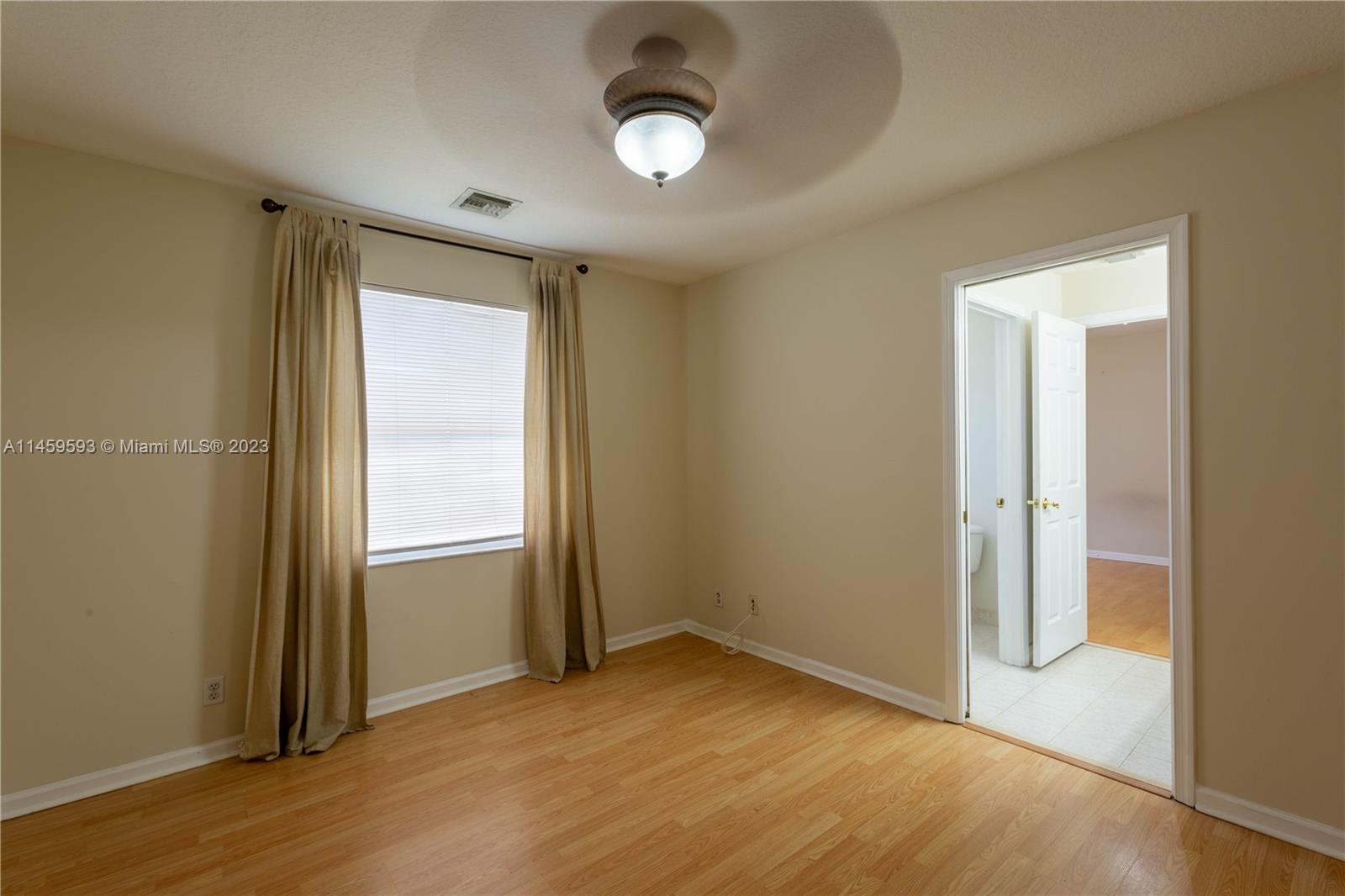 Sunset Lakes Miramar, FL 33029 - Photo 28 of 51 an empty room with wooden floor closet and windows