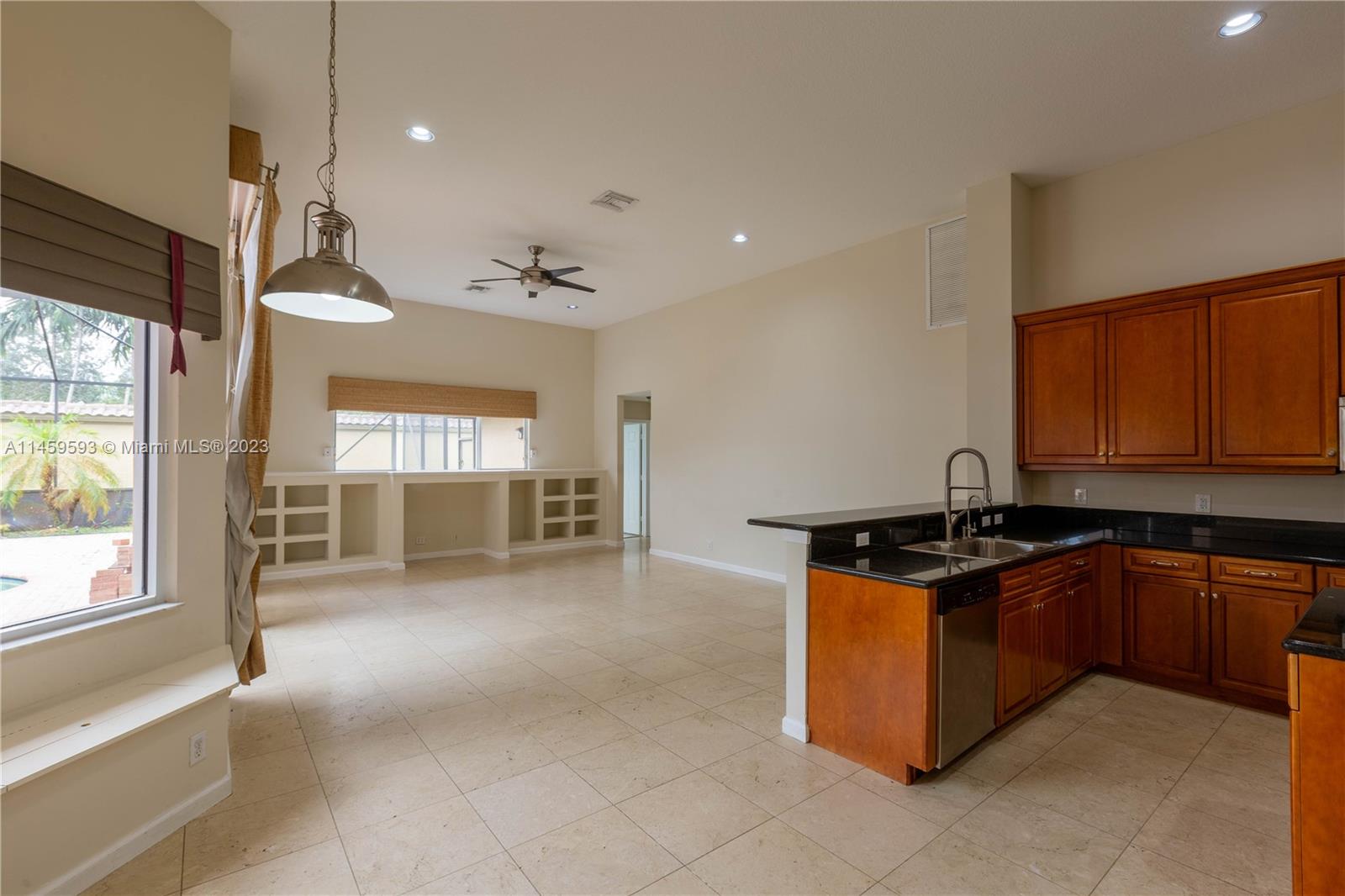 Sunset Lakes Miramar, FL 33029 - Photo 29 of 51 a kitchen with stainless steel appliances granite countertop a stove a sink and a refrigerator