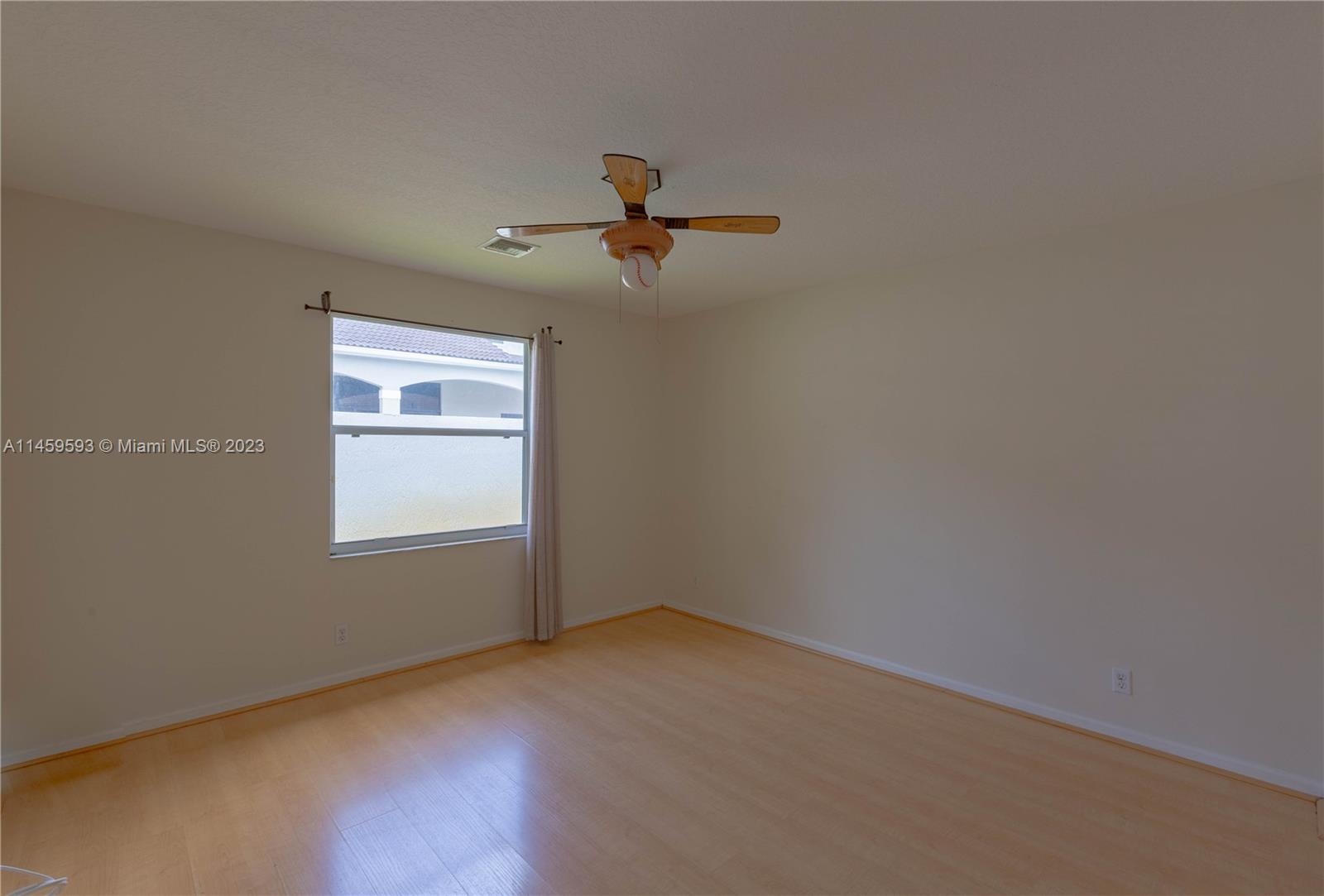 Sunset Lakes Miramar, FL 33029 - Photo 39 of 51 an empty room with a window and a ceiling fan