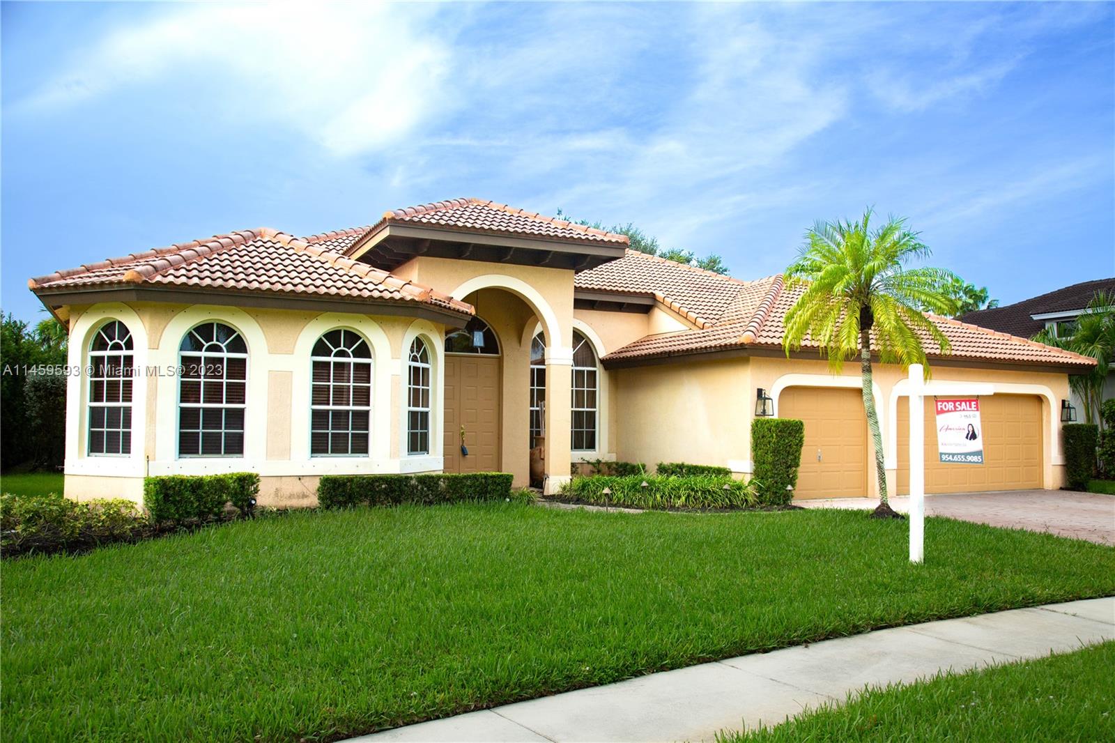 Sunset Lakes Miramar, FL 33029 - Photo 4 of 51 a front view of a house with a garden