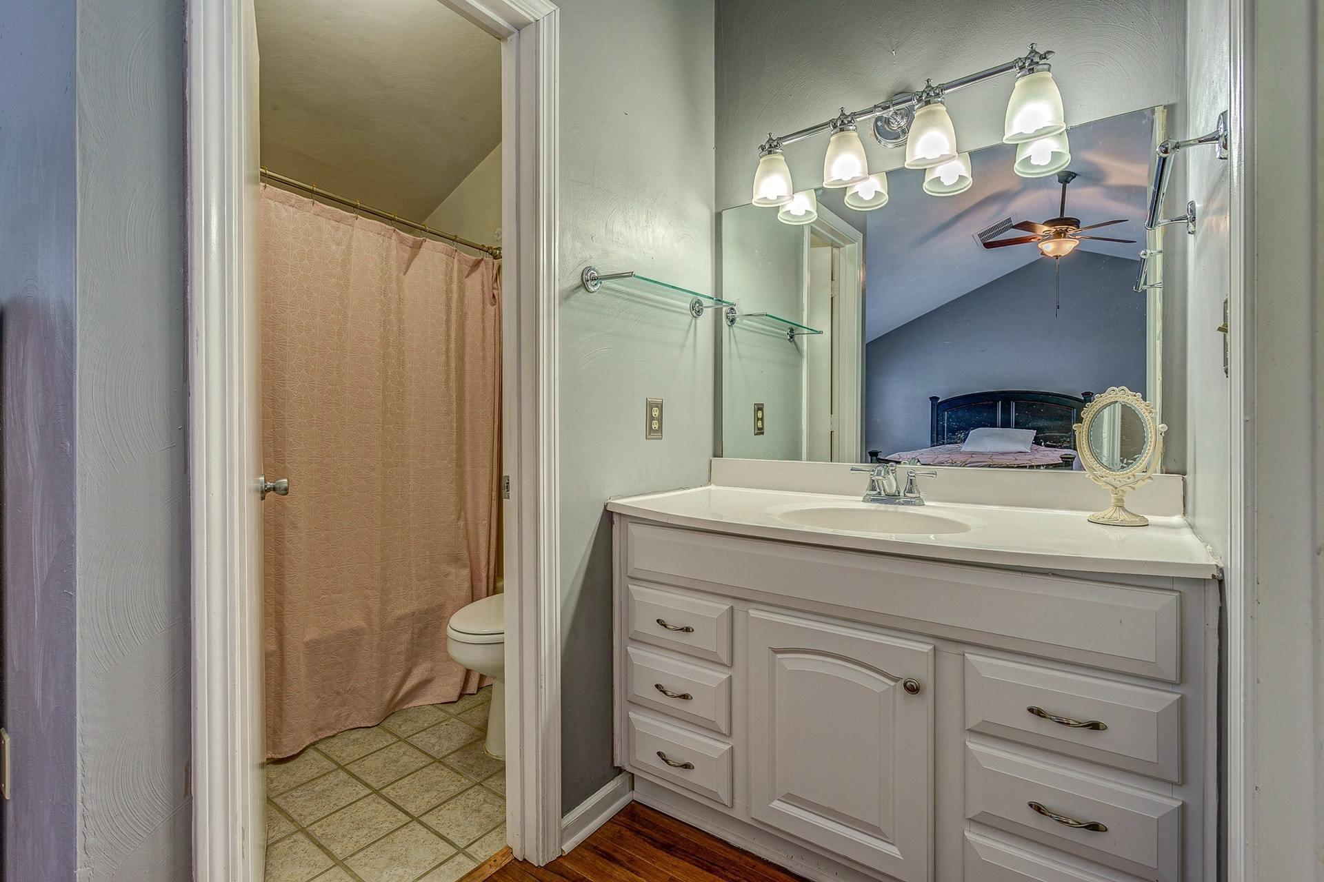 3269 Forest Ridge Road Roanoke, VA 24018 - Photo 13 of 14 a bathroom with a granite countertop sink a toilet and a mirror