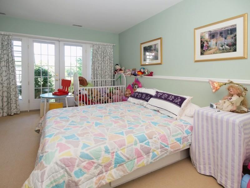 284 Hawks Hill Road New Canaan, CT 06840 - Photo 18 of 23 a bedroom with a bed and a painting on the wall
