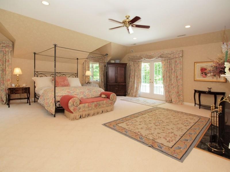 284 Hawks Hill Road New Canaan, CT 06840 - Photo 10 of 23 a bedroom with a bed a window and couch