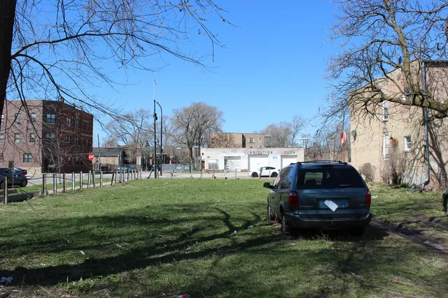 a car parked in the grass near a building