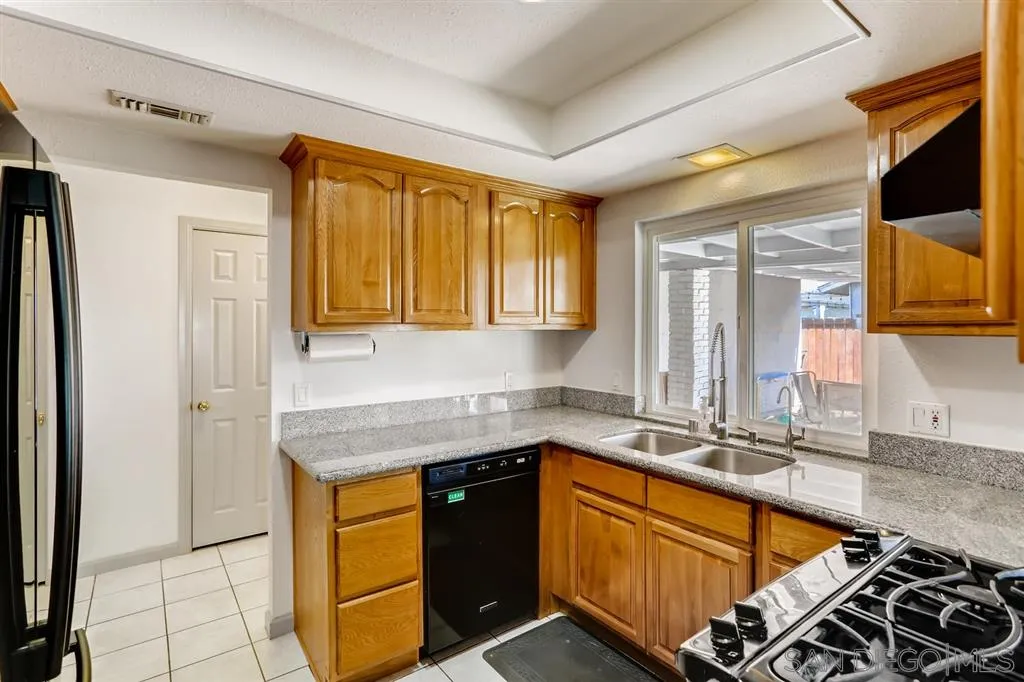 13131 Chrissy Way Lakeside, CA 92040 - Photo 11 of 25 a kitchen with stainless steel appliances granite countertop a sink stove and cabinets