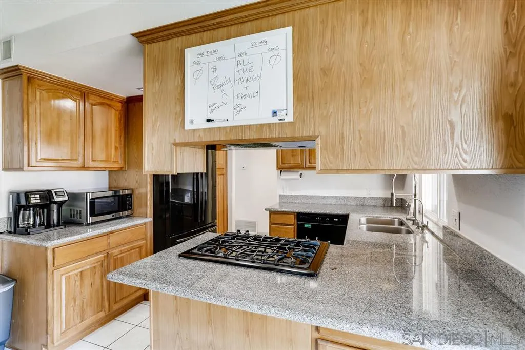 13131 Chrissy Way Lakeside, CA 92040 - Photo 12 of 25 a kitchen with stainless steel appliances granite countertop a stove a sink and a microwave