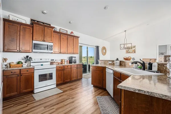 a view of kitchen with sink and wooden floor