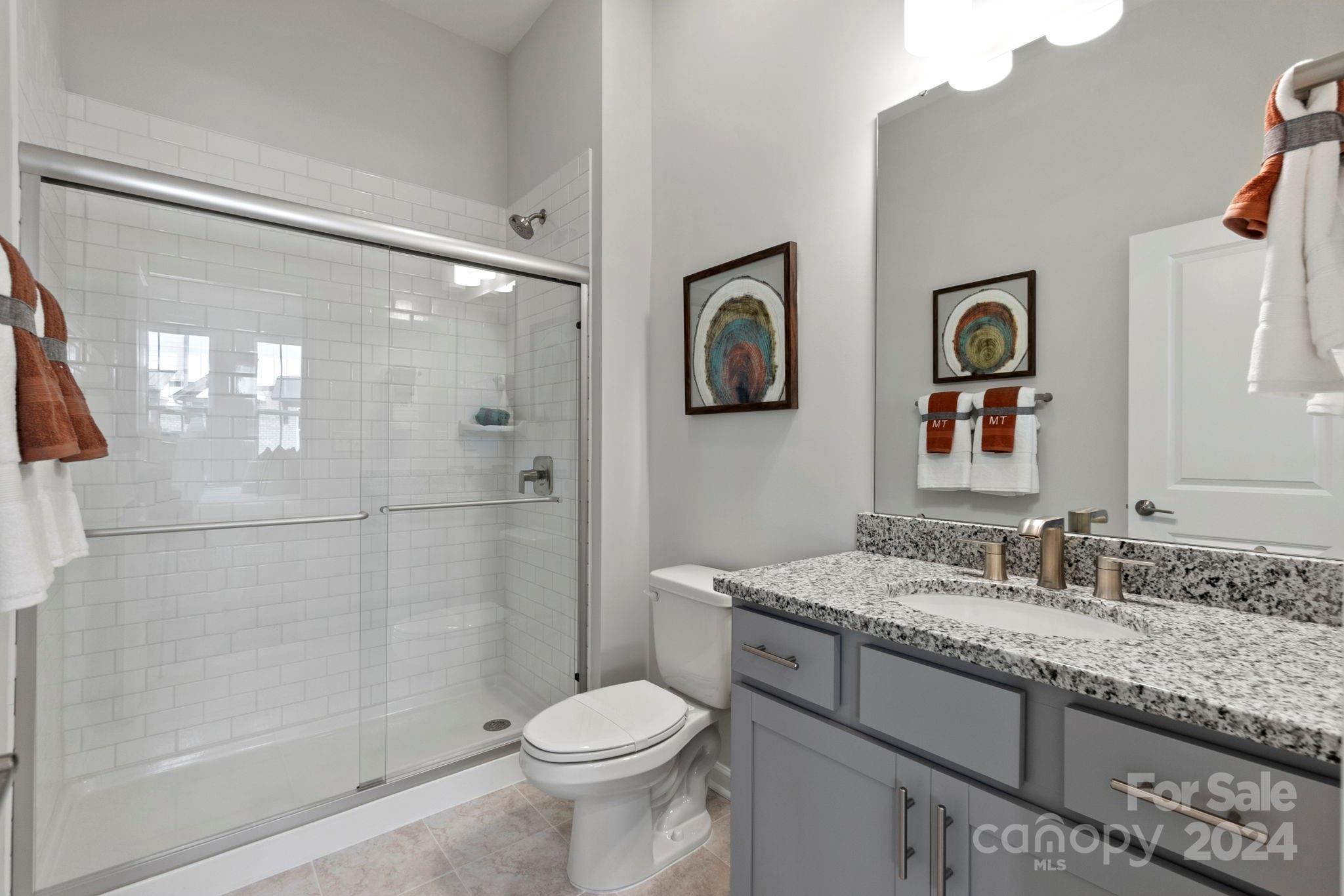 1133 Lost Cv Road Indian Land, SC 29707 - Photo 20 of 42 a bathroom with a granite countertop sink toilet and shower